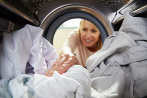 Woman looking at clothes in dryer