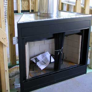 A brand new prefab fireplace system during the installtion process