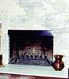 A smoke guard on a fireplace to prevent smoking problems
