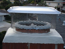 A chimney with a top sealing damper and chimney cap