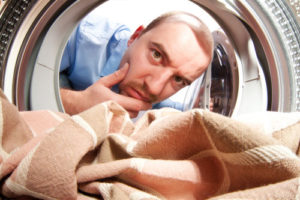 Man looking into dryer